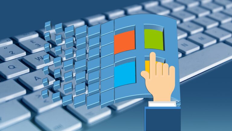 Hand pressing a Windows logo above a computer keyboard