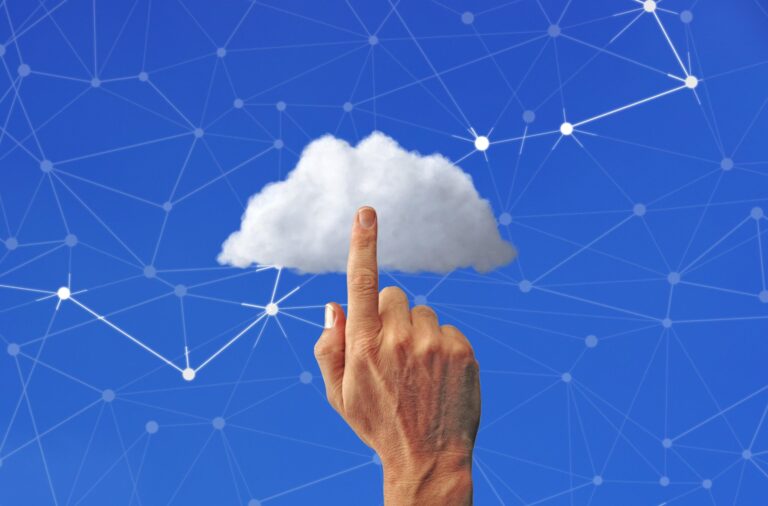 Finger touching a cloud on a blue network diagram