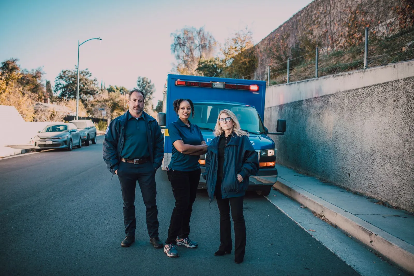 EMS crew standing in front of an ambulance