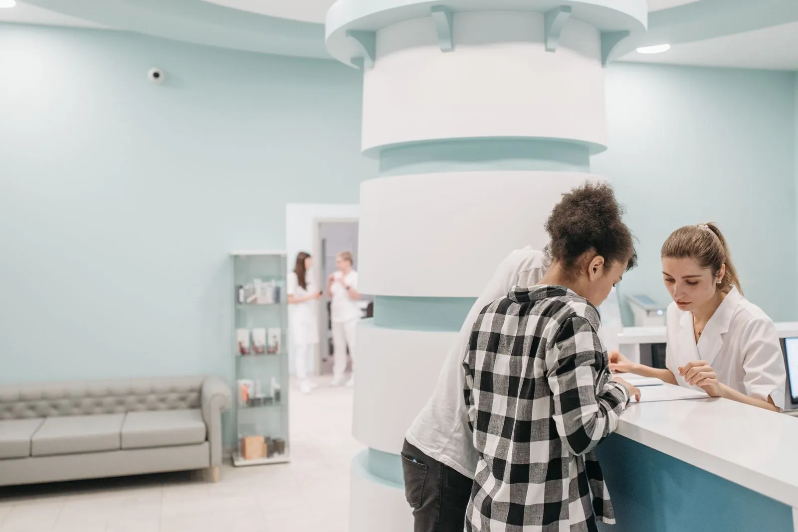 Patient checking in at a medical clinic reception desk