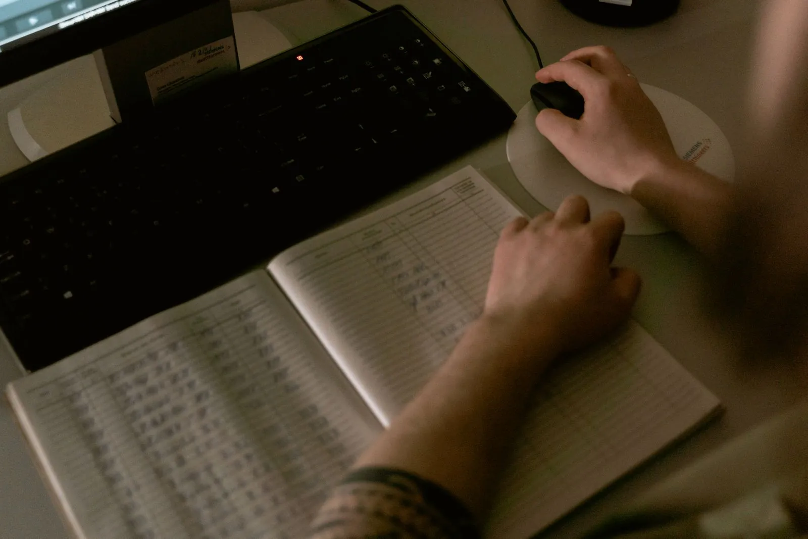 Healthcare worker reviewing records on a computer