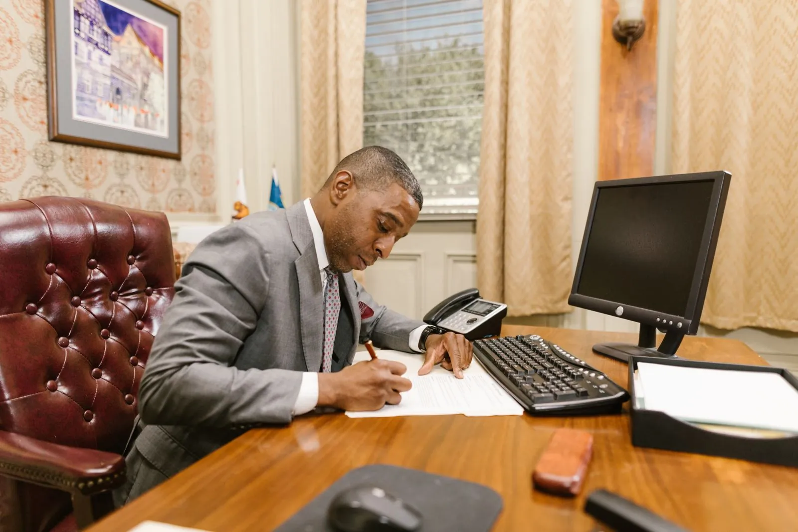 Attorney writing at a desk in a law office